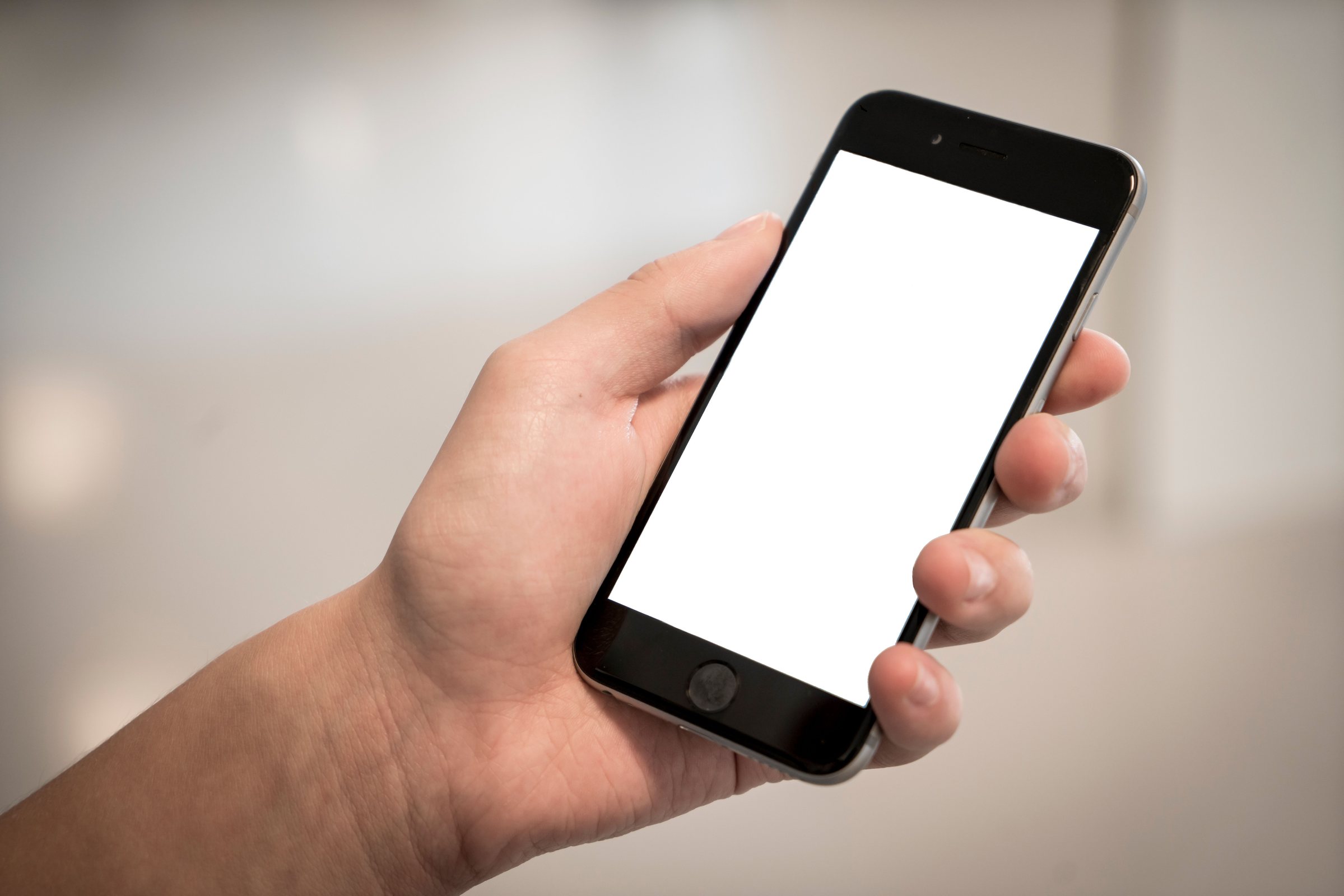 Real hand holding a phone